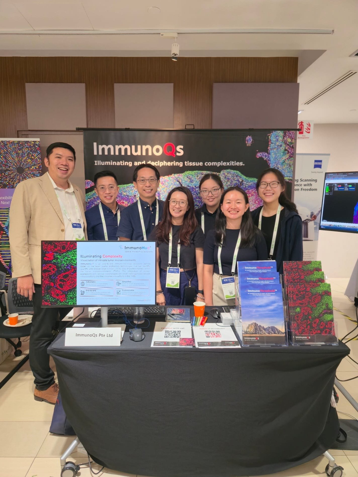 The team at the ImmunoQs booth at SITC 2025