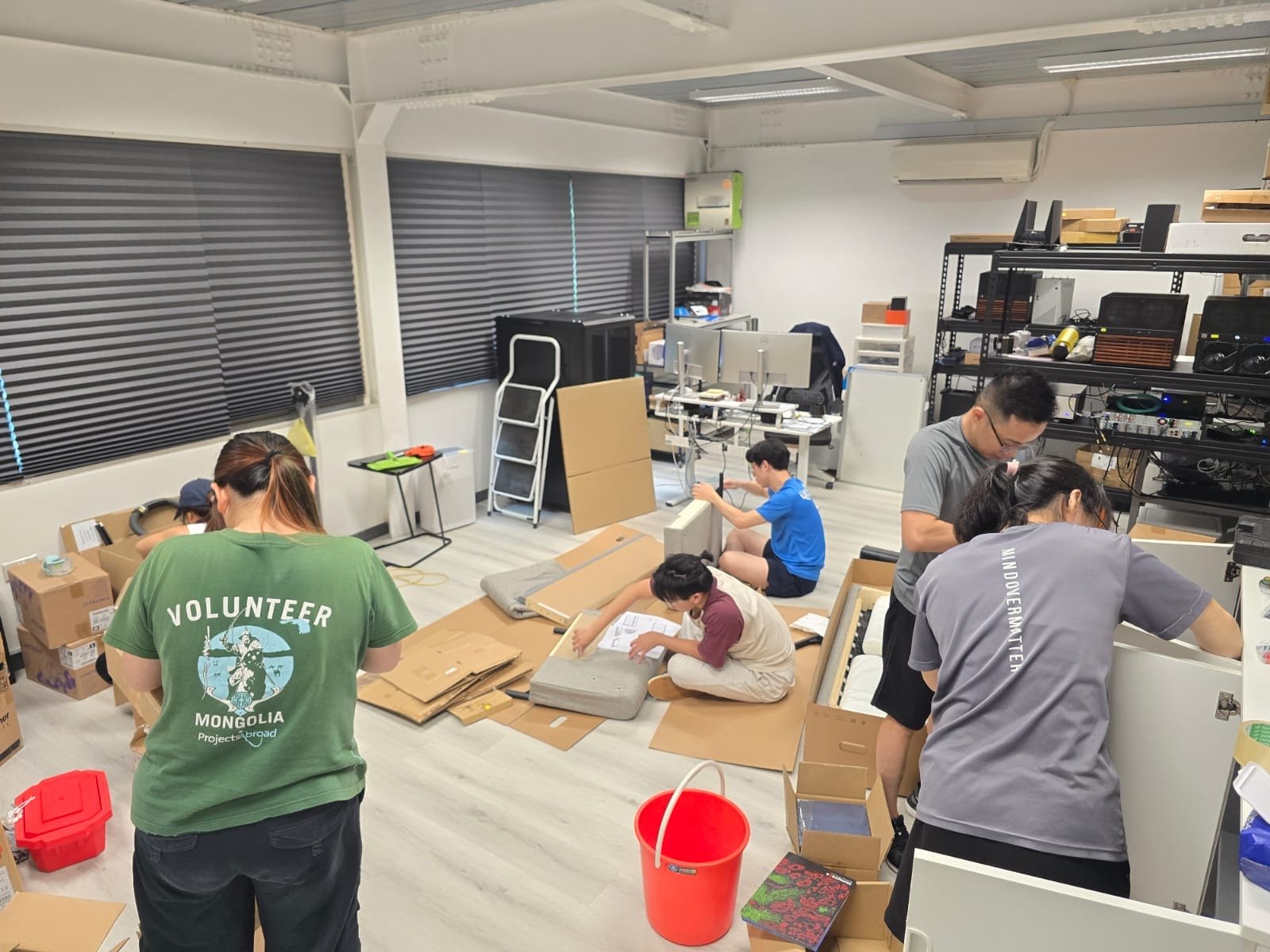 The team assembling furniture in the new office