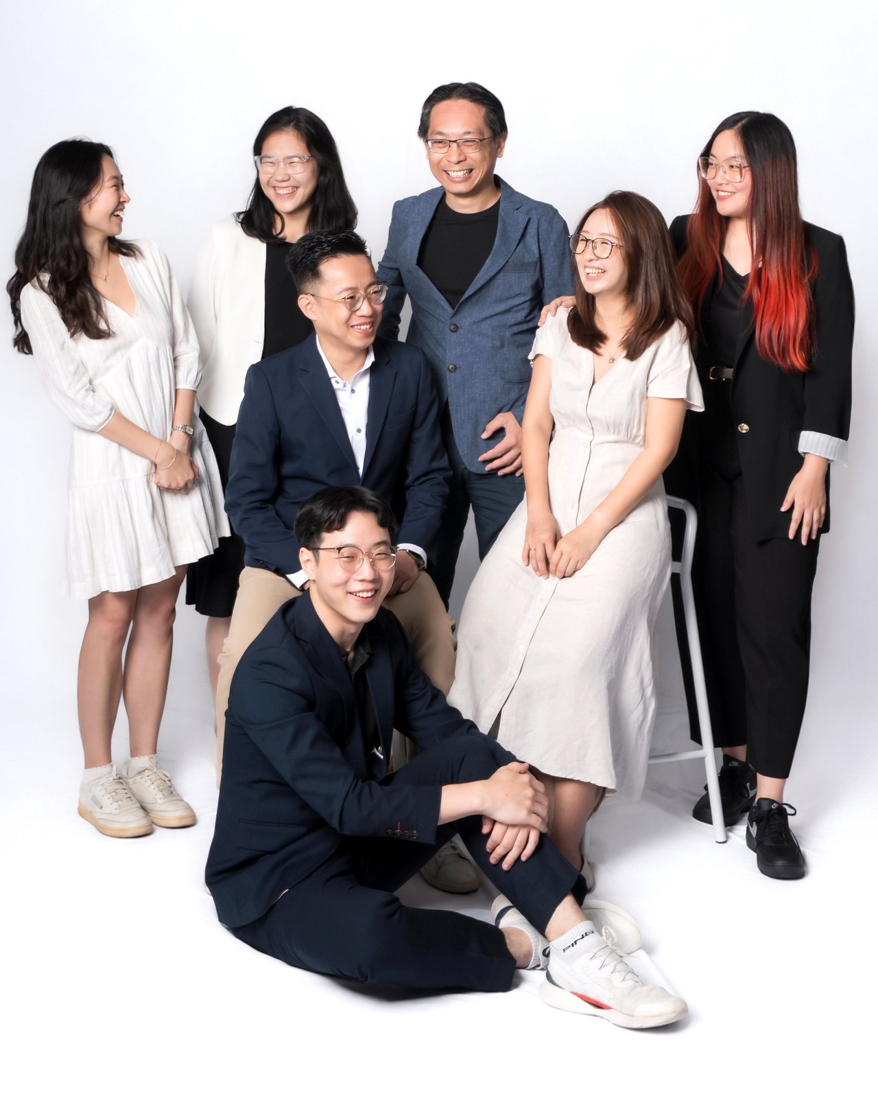 The team posing for a studio group portrait